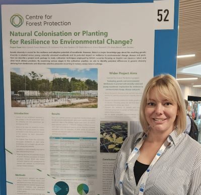 woman in front of a poster