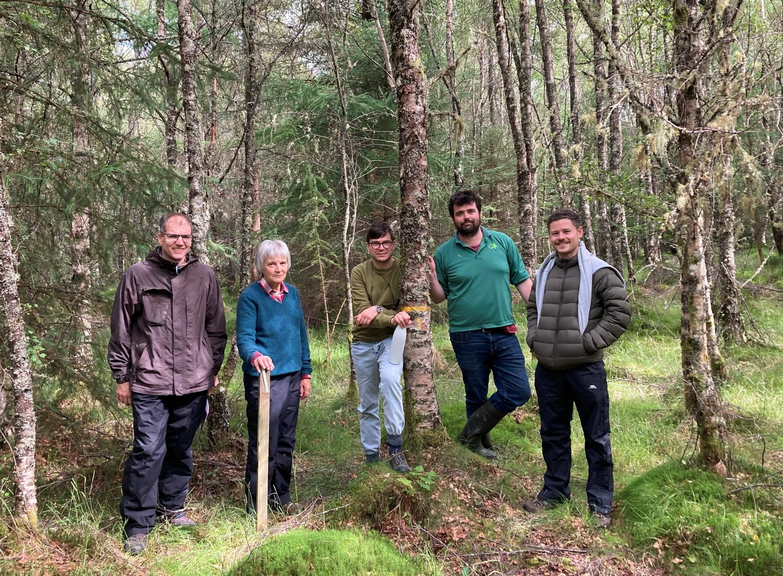 Team of scientists standing in the forest at Loch Tay